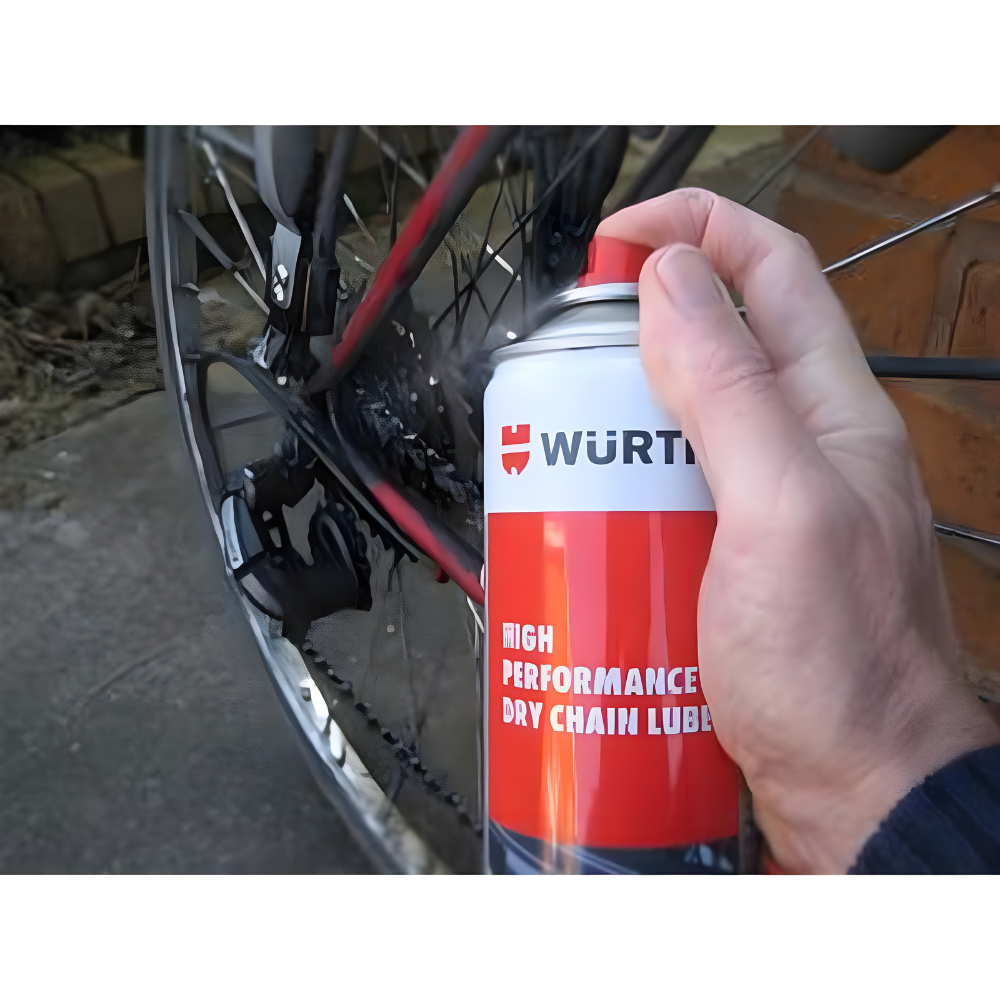 wurth-high-performance-dry-motorcycle-chain-lube-150ml-spray-bicycle-chain wurth high performance dry motorcycle chain lube 150ml being sprayed on bicycle chain for smooth movement, corrosion resistance, and o-ring safe lubrication