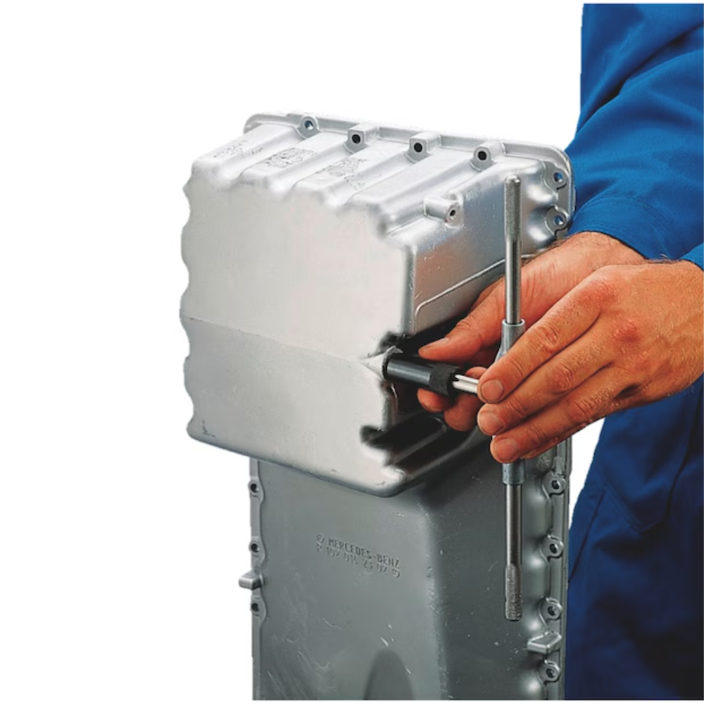 TIME-SERT M12 x 1.5 tap with guide in use – demonstrates accurate thread cutting and alignment during an oil drain plug thread repair.